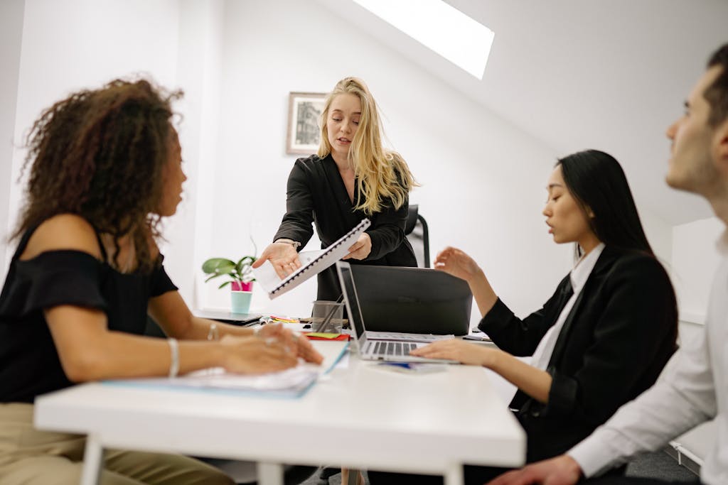 Diverse team engaged in a business meeting, collaborating and discussing ideas.